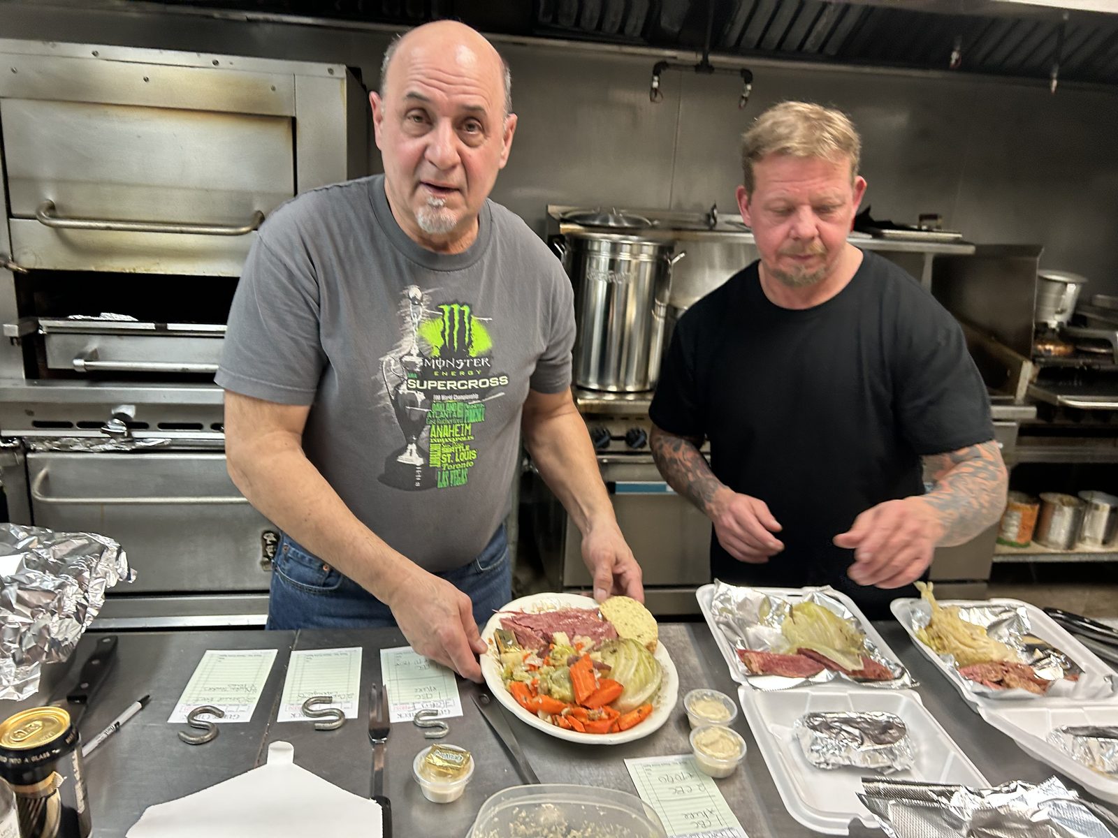 Volunteers cooking in the lodge kitchen