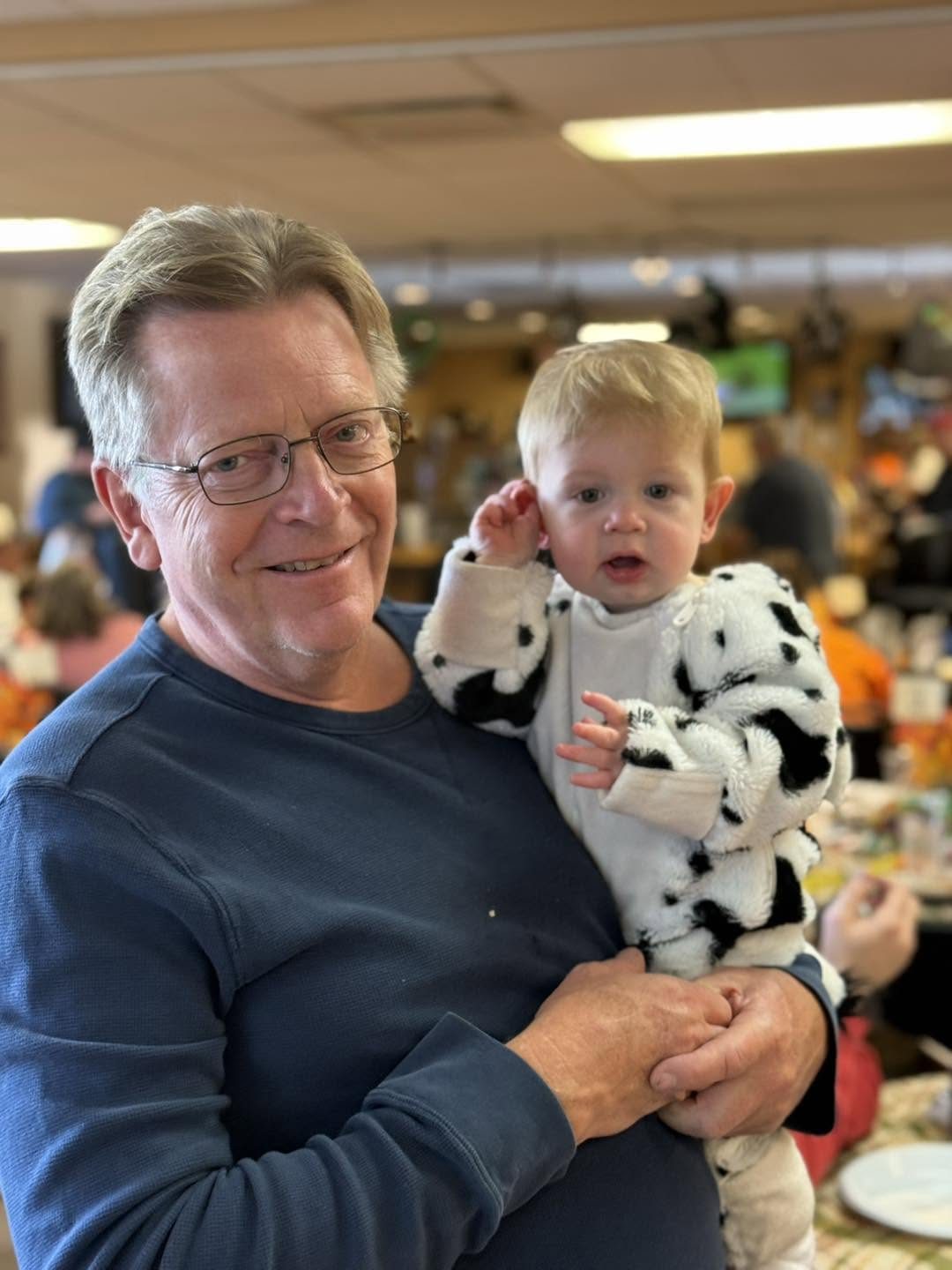 Lodge member holding a grandchild at the lodge